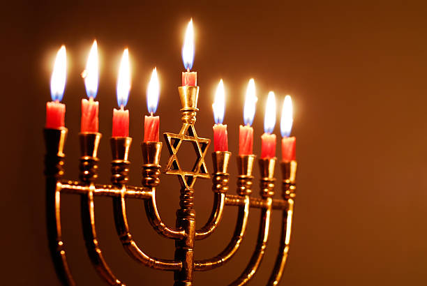 Star of David Hanukkah menorah Candles lit for the eighth night of Hanukkah hanukkah stock pictures, royalty-free photos & images