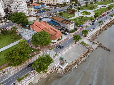 City of Santos, Brazil. October 13, 2021: Aerial view of the city of Santos in the Ponta da Praia neighborhood. Municipal aquarium, square, gardens, bike path, beach and promenade.
