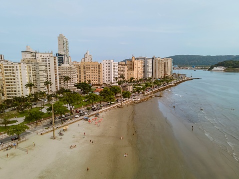 Santos city, Brazil. October 13, 2021: Aerial view of Santos city at sunset in Ponta da Praia neighborhood. Aquarium, square, gardens and fountains, beach promenade and the sea.