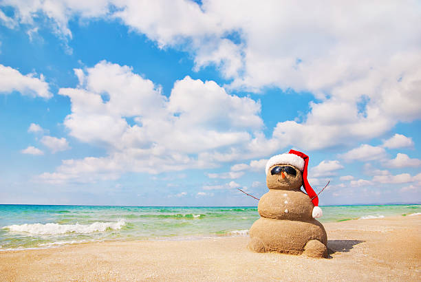 Photo of Snowman made out of sand. Holiday concept.