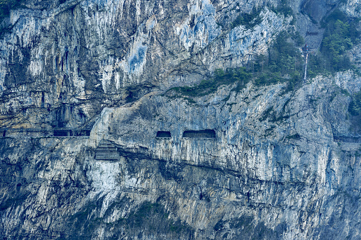 Scenic view of rock with cliff and road at lakeshore of Lake Lucerne . Photo taken May 22nd, 2023, Sisikon, Switzerland.
