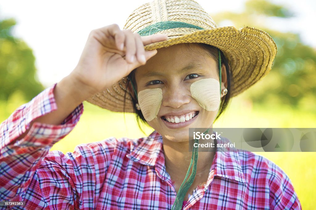 Burmese woman Portrait of a young Burmese woman with thanaka powdered face who works in the field Adult Stock Photo