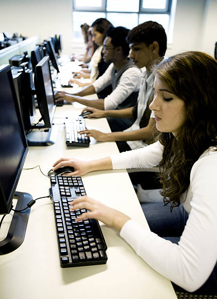 istock further education: teenage students candidly working in their computer lab 157393874