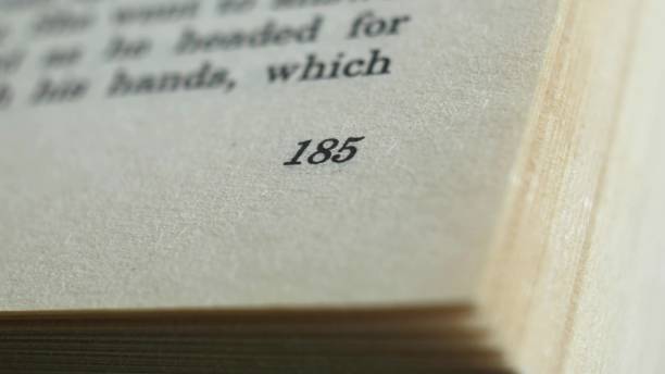 istock Flicking Through Old Book Page Numbers Close-up 1573939510