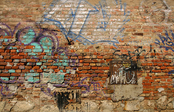 Scribbled Brick Wall Phot was taken with a fixed 30 mm lens. Aperture value: f/5.6; ISO speed ratings: 100; Shutter speed: 1/640 sec. brick wall photos stock pictures, royalty-free photos & images