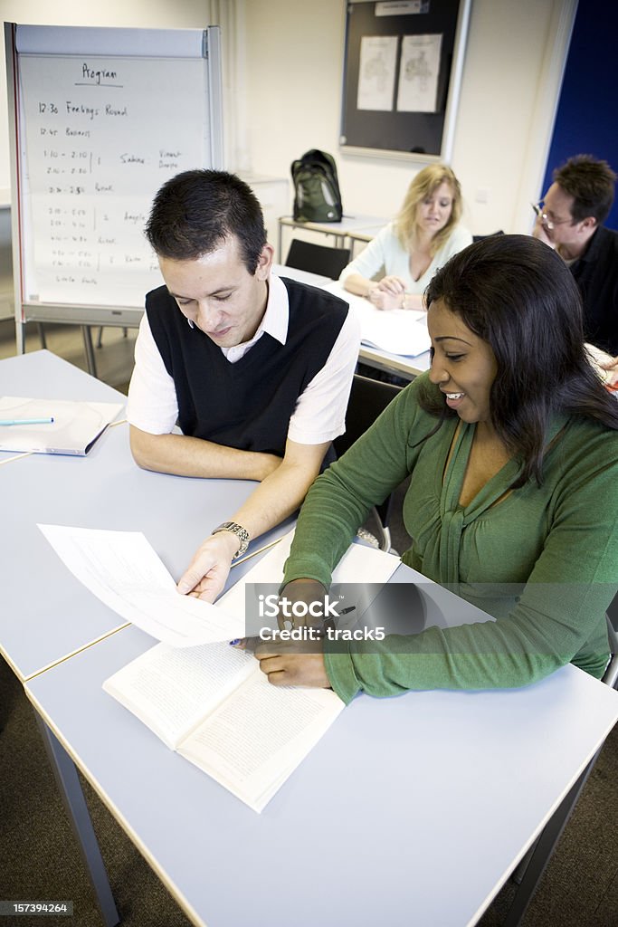 adult education: mature students working together in the classroom  Nontraditional student Stock Photo