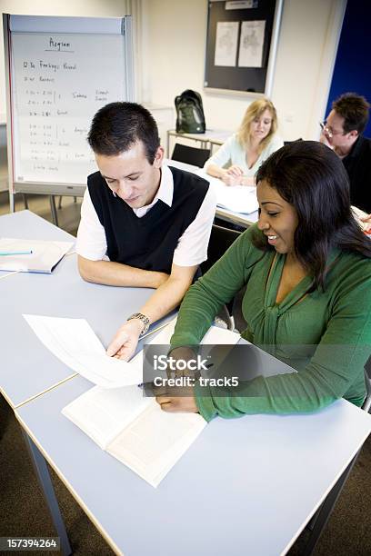 Adult Education Mature Students Working Together In The Classroom Stock Photo - Download Image Now