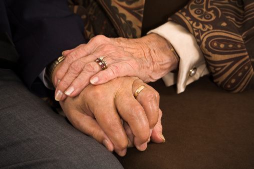 senior married couple holding hands: sixty years of faithfulness