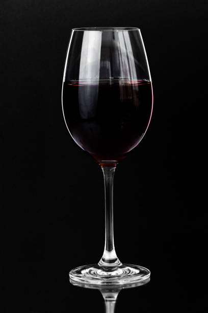 istock Red wine in a glass on a dark background with copy space. 1573945493