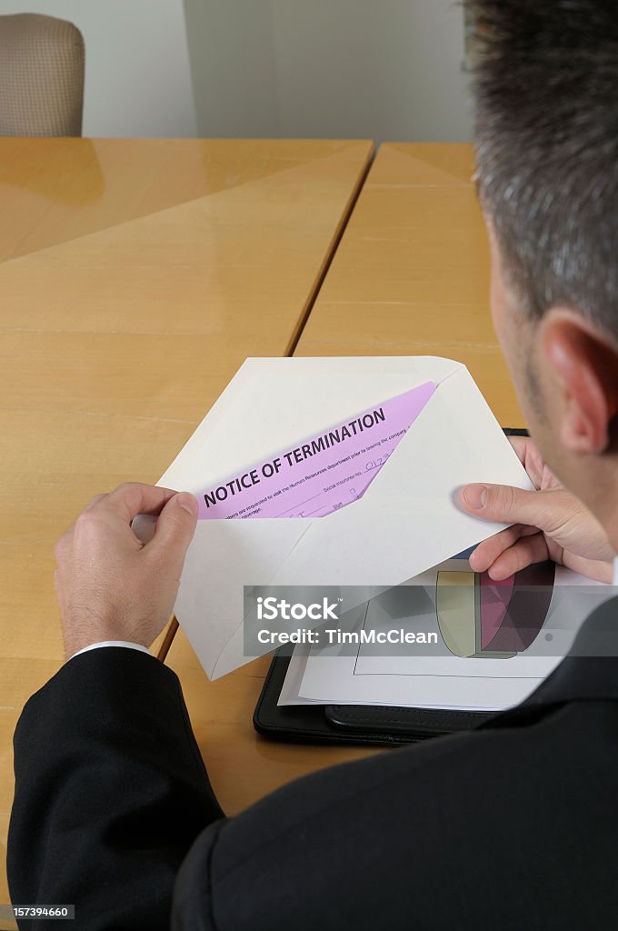 Man opening an envelope containing notice of termination Job termination Falling Stock Photo