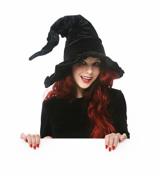 istock Young girl dressed as a witch isolated on white  157394855