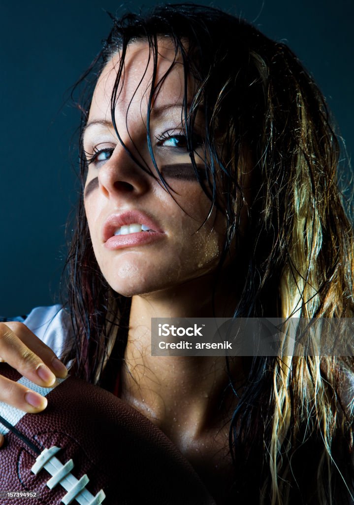 Sweaty football player Sweaty female football player on dark background. 20-29 Years Stock Photo