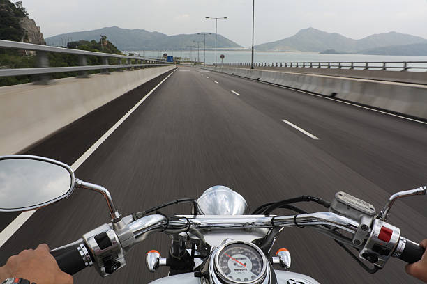 バイクで疾走する - motorcycle handlebar road riding ストックフォトと画像