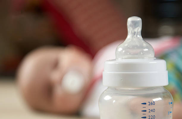 Baby and bottle scale in focus stock photo