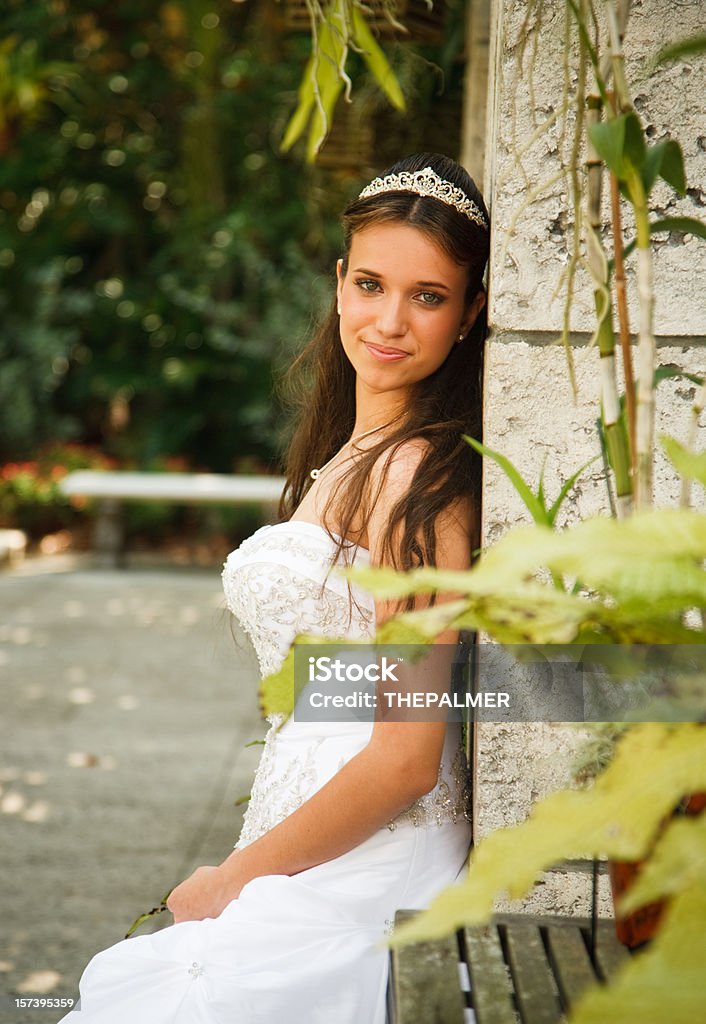 quinceanera quinceanera girl leaning against an old column in a park 14-15 Years Stock Photo