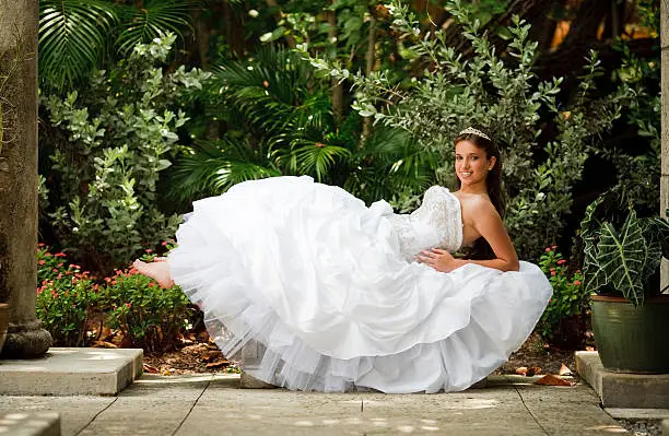 sweet sixteen latin girl posing in a bench