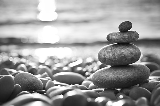 Balanced stones on a beach - black and white photography