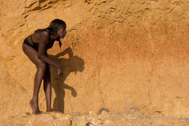 istock African woman standing in a strange position 157396281