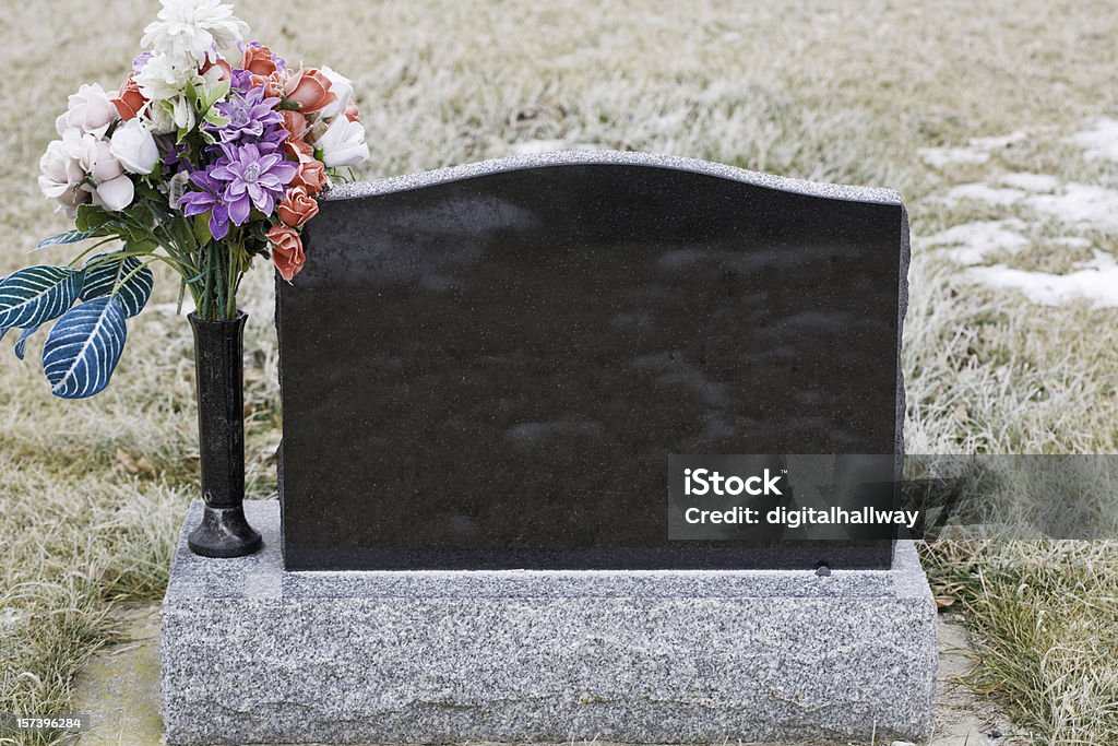 Gravestone in Winter Gravestone in winter Cemetery Stock Photo