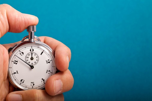 Vintage, analog stopwatch in hand.