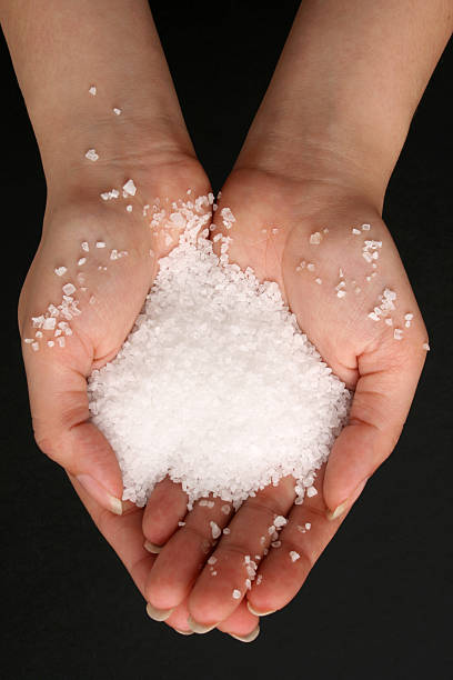 istock A close-up of a woman's hands holding salt 157396313