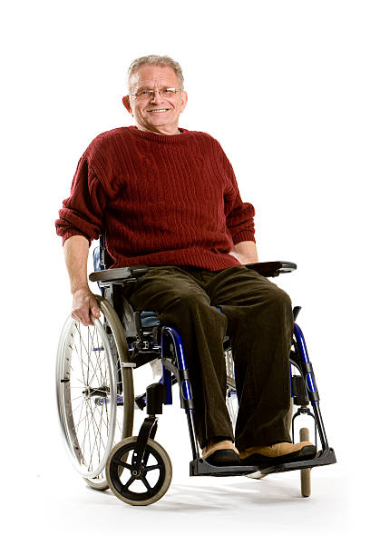 Paraplegic handicapped man gesturing in wheelchair by lake on wooden pier