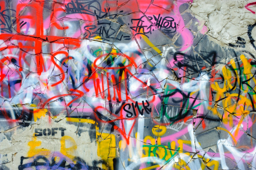 Abstract colorful graffiti drawn on white brick wall