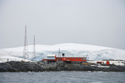 Argentine Antarctica Research Base on Melchior Islands, Antarctica. Orange Red Rescue Houses at the Coast to the Antarctic Ocean.