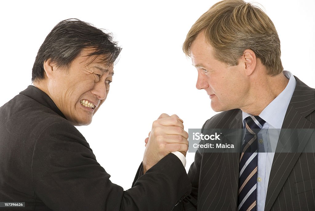 Pulse Strength competition between an asian and a caucasian man. Arm Wrestling Stock Photo