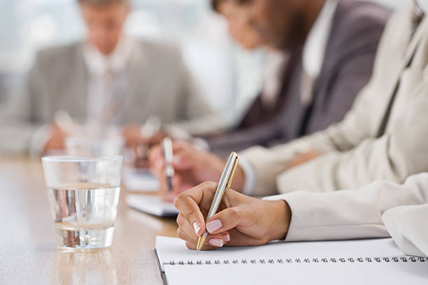 istock Closeup of businesspeople writing 157396961