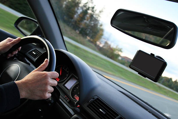 istock Man Driving Car Down Road with GPS Navigation Installed 157397019
