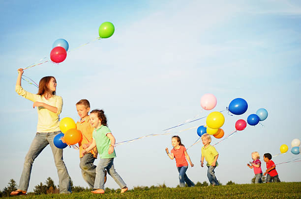 istock Group of Children Walking while Holding Balloons 157397310