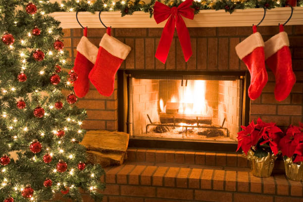 istock Christmas tree and decor around the fireplace with blazing fire 157397473