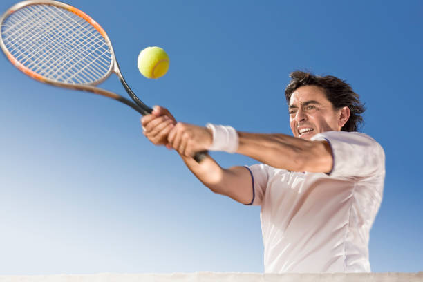 istock Blue sky over tennis player hitting the ball 157397691