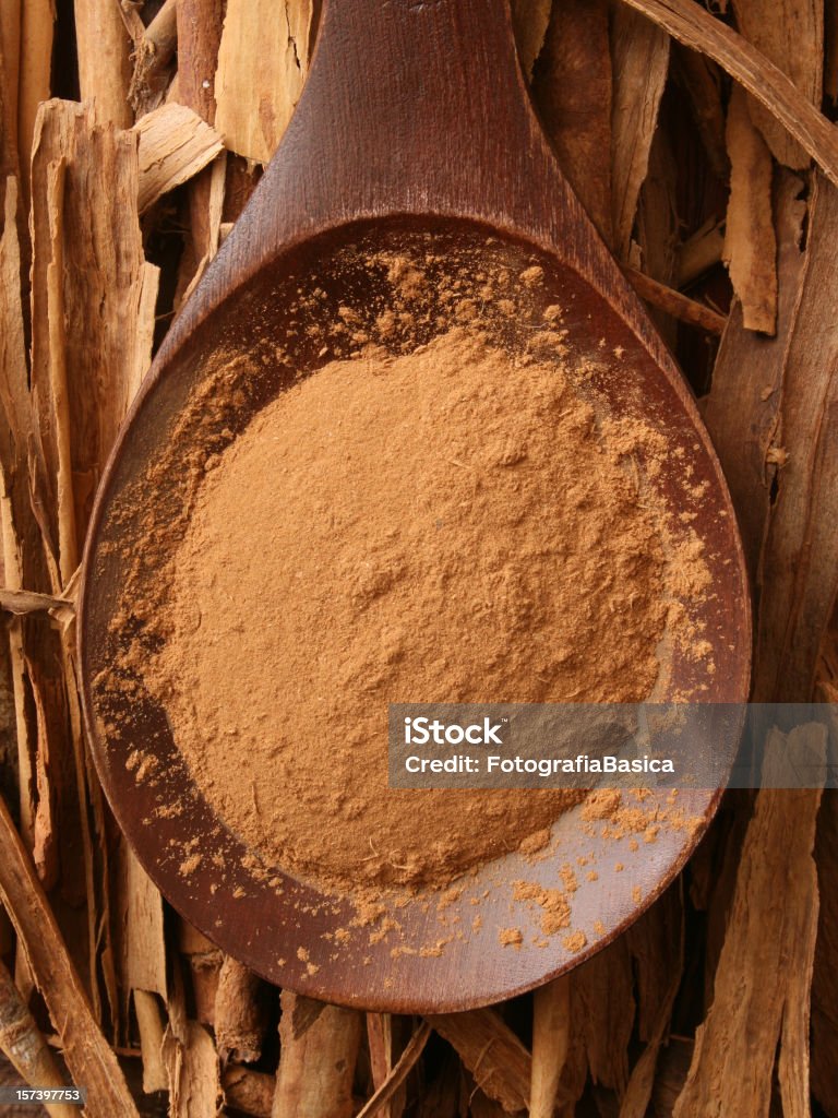 Ground cinnamon Top view of wooden spoon full of ground cinnamon Brown Stock Photo