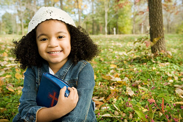 Little Girl Happy with a Bible stock photo