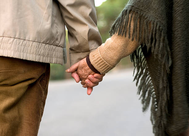 istock happy senior couple walking on the way 157398109