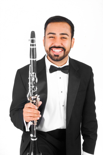 Young Mexican-American musician holding his clarinet