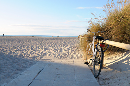 Bike leaning at wooden fence at the beach, Miami, USA.