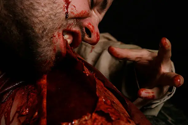 *THIS IS NOT REAL - SPECIAL EFFECTS MAKE UP* Person having flesh ripped off by cannibalistic man. Very graphic , shocking and disturbing, but come on who doesn't need a picture of a cannibal?