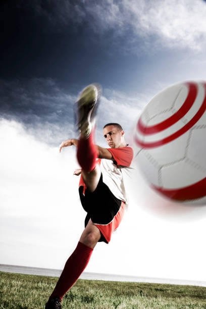 istock Male soccer player kicking ball at a camera 157398205
