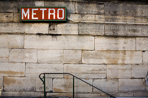 Brick wall and slope with a red Metro Sign on top stock photo