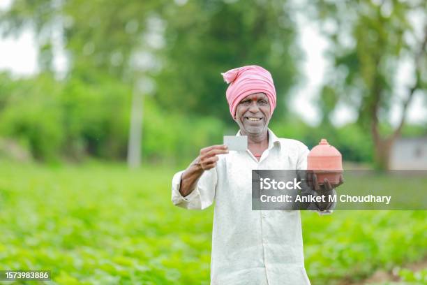 Indian Farmer Holding Gullak In Hand Saving Concept Happy Poor Farmer Stock Photo - Download Image Now
