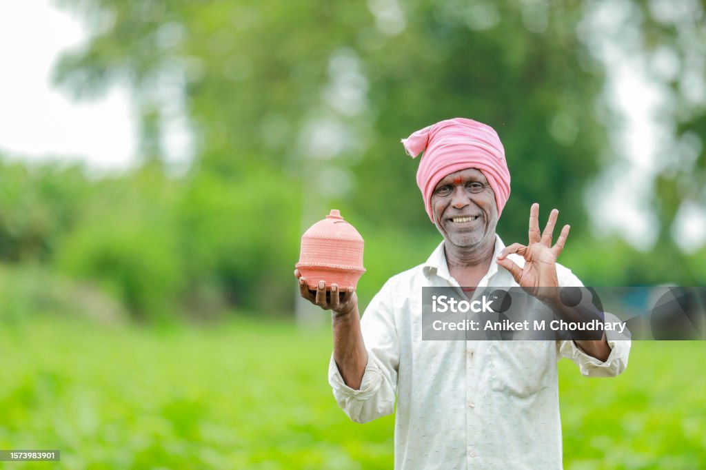 Indian farmer Holding gullak in hand, saving concept, happy poor farmer Adult Stock Photo