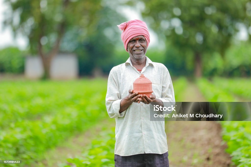 Indian farmer Holding gullak in hand, saving concept, happy poor farmer Adult Stock Photo