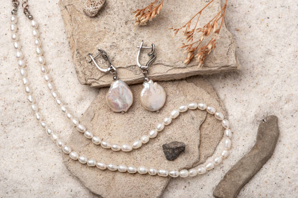 istock Beautiful Pearl Jewelry on white sand. 1573985514