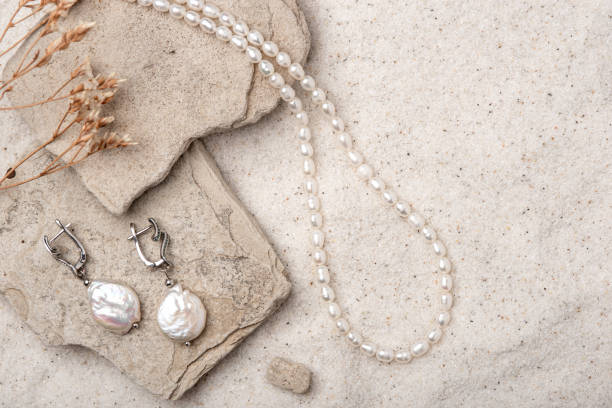 istock Beautiful Pearl Jewelry on white sand. 1573985521