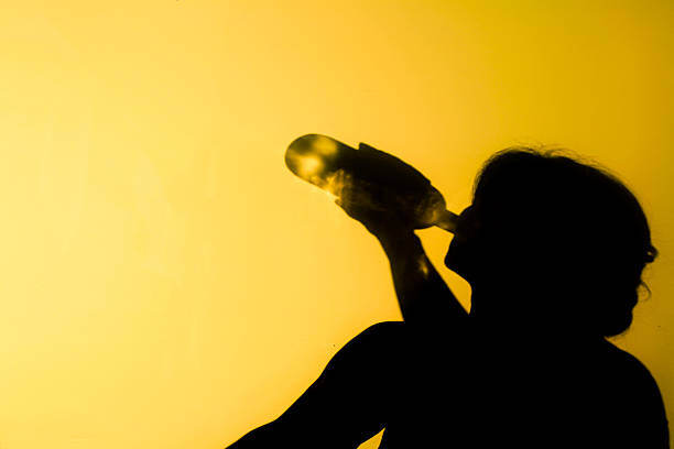 Alcoholism Shadow of an alcoholic woman. alcohol abuse stock pictures, royalty-free photos & images