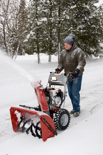 A man with his Snow Blower.