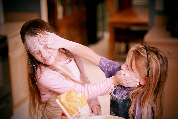 Sibling Rivalry -Food Fight - Children In The Kitchen Series stock photo
